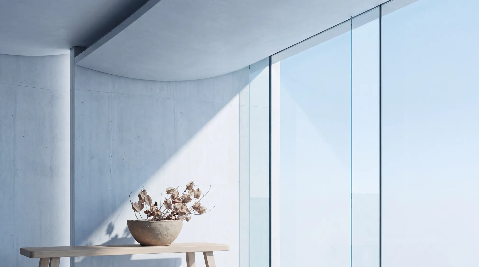 Modern grey vase next to a window with plenty of light